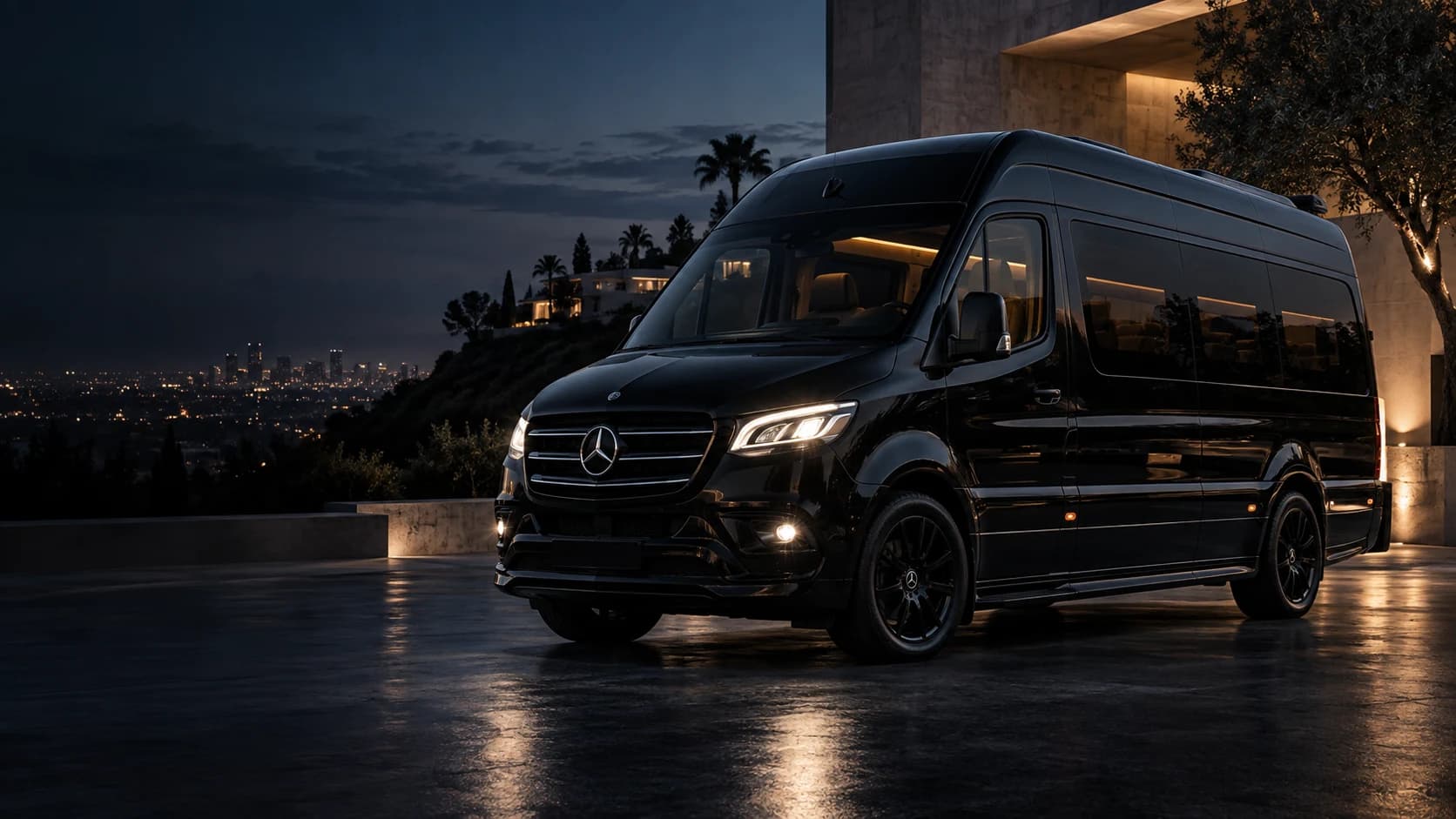 Black JETXLA Sprinter at a hillside residence overlooking Los Angeles at dusk